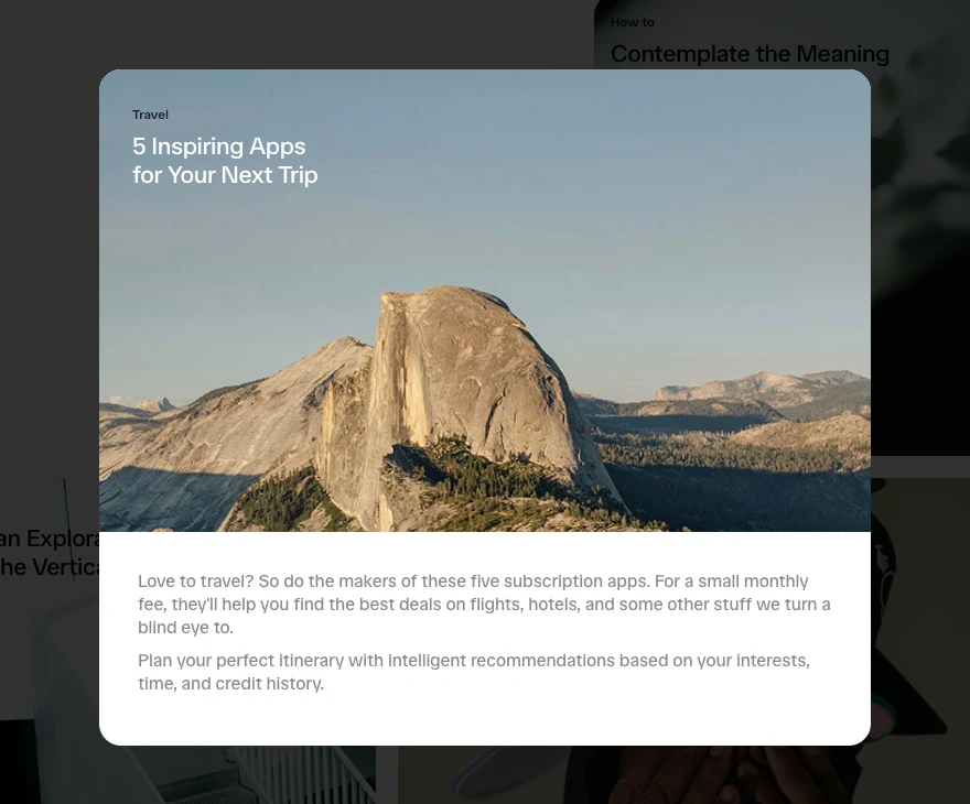 After the Travel card is clicked, Motion’s official app-store demo displays the same mountain photograph and title in a larger centered panel. A white text section appears below the image, and the other cards remain visible behind a dark overlay.